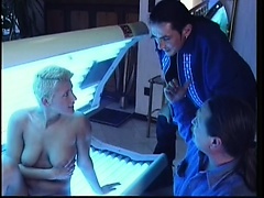 Blonde in a tanning booth gets a stick to eat and gets fucked inside