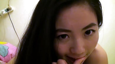 Taiwanese girl Lin Xiaoxia explores her body in private on a dimly lit bed