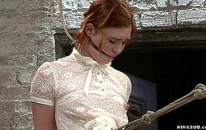 Bound redhead zappered on hogtie
