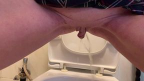 Peeing standing over Toilet and showing Tits