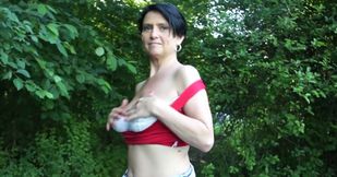 Busty mature flashes her naturals in public to a young man