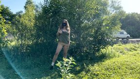 Tattooed girl flashing near road