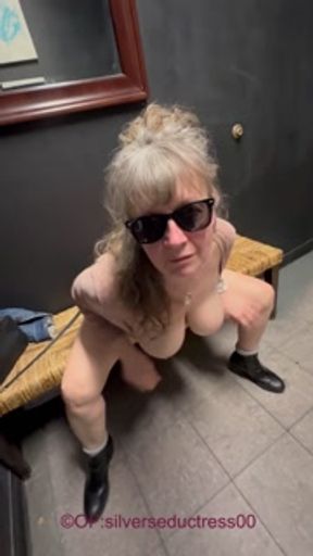 Mature mom playing in porn theater bathroom.