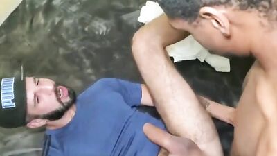 White bearded man is poked in the ass with black man's dick