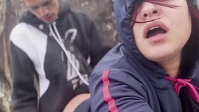 Hooded beauty sucks and rides young guy hard on rocky beach