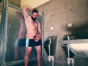 Furry muscle hunk shows off his big thick cock at the public urinal
