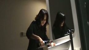 Naughty playful Chinese girl masturbating with a bottle