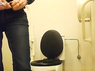 Woman squats over lavatory to pee