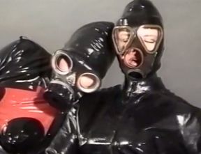 Insane fetish action with two sluts in latex body and gasmasks