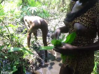 two Afro tribe angel having enjoyment with the village chief in the centre of the forrest