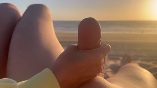 Public handjob. Hand job on a nude beach. We were caught jerking off at sunset near the ocean