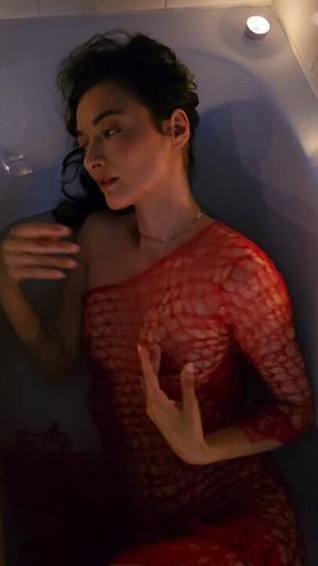 Sensual and horny brunette with red transparent dress make sensual bath