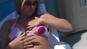 Hot blonde Paige plays with her big tits while applying sun lotion