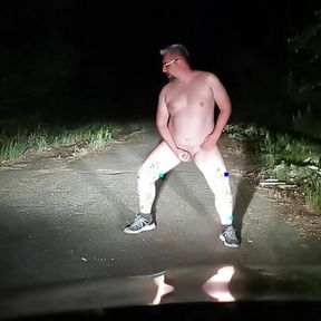 Fat bastard Dennis jerks off in front of his car at night.