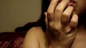 Busty latina brunette licking her fingers on the webcam