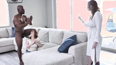 Foxy redhead MILF and younger hottie share a huge black cock
