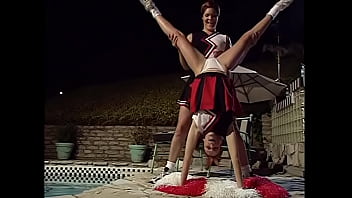 Two cheerleaders enjoy in swim pool with each other&#039_s tits and pussies