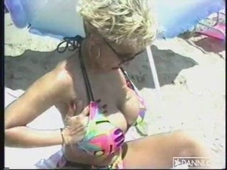 Danni Ashe with Big Tits Fingers Her Snatch While Tanning on the Beach