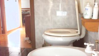 Red-haired college girl gets naked and pisses on the WC