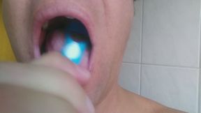 Cleaning my tongue with a tongue cleaner, showing my tongue, uvula and spit